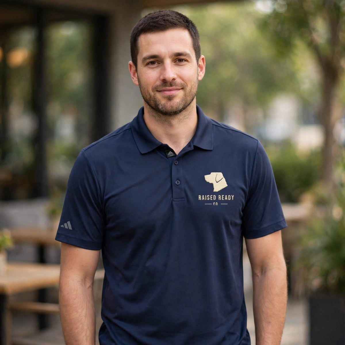 adidas polo worn by a man, navy